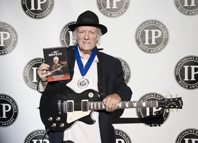 Dick holding Ippy Award